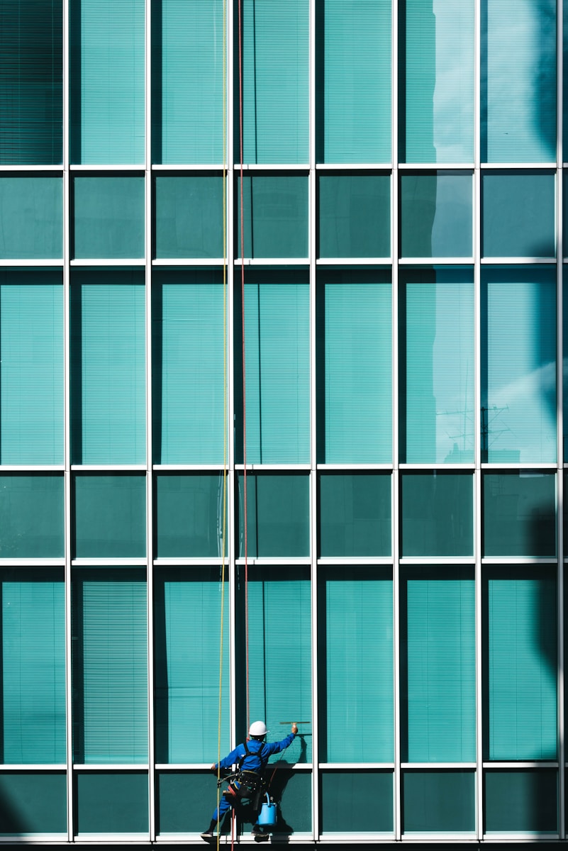 Photo by Ryoji Iwata man cleaning glass mirrors